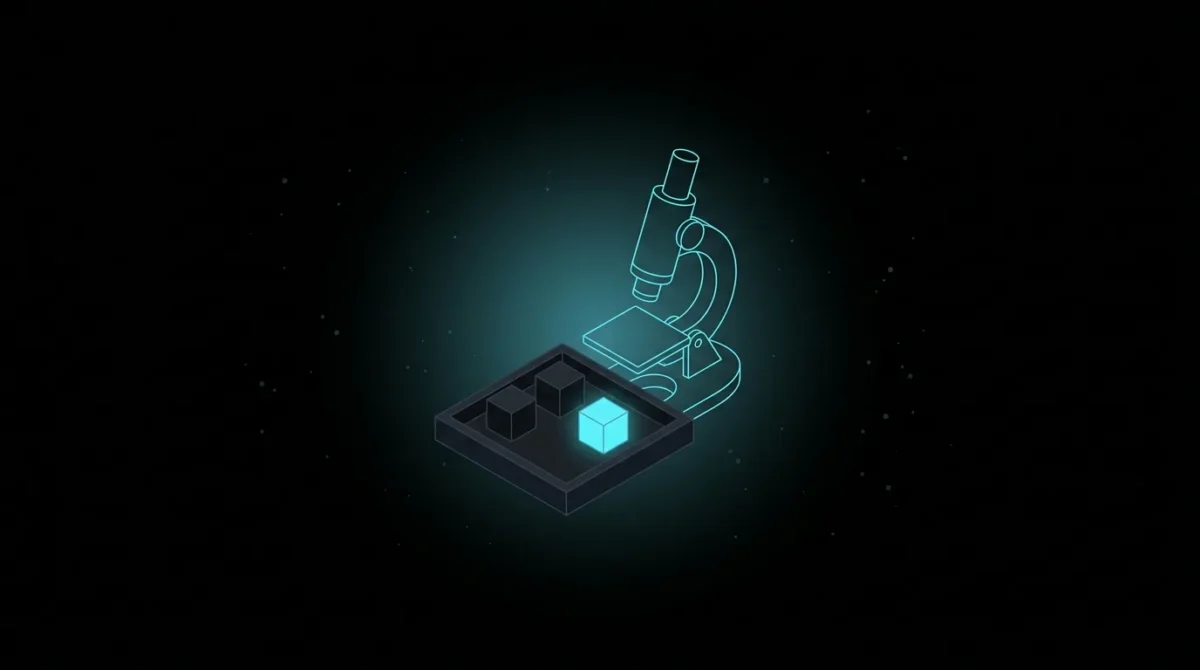 Microscope examining a tray of three cubes, one glowing
